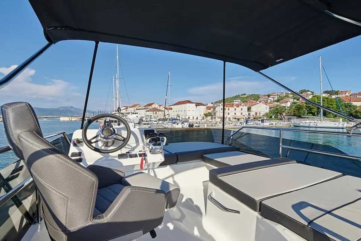 Cockpit of Merry Fisher 1095 Fly, a Jeanneau Merry Fisher 1095 Fly motorboat at Grad Trogir, Croatia