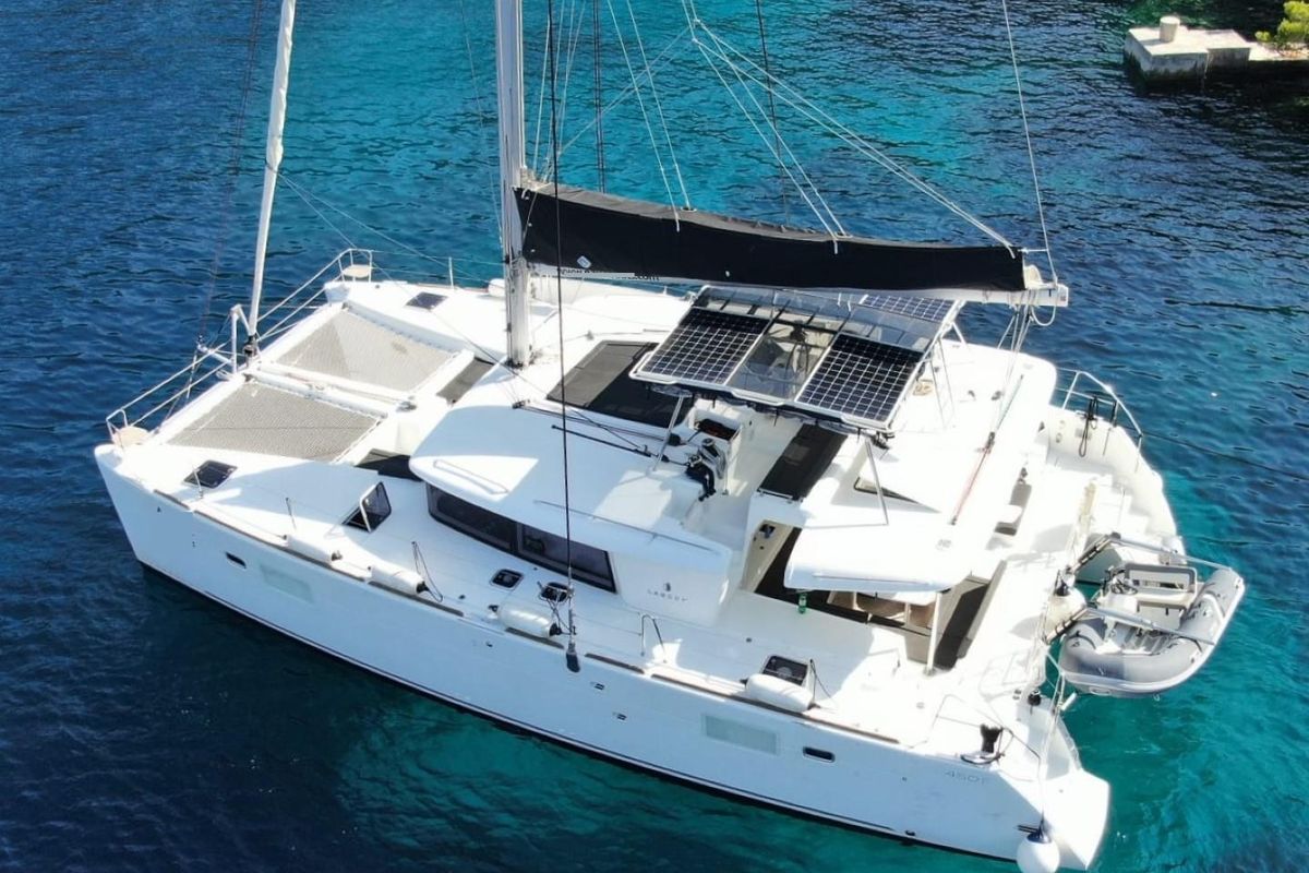 Exterior view of Carmela, a Lagoon 450 Fly catamaran at Sant Antoni de Portmany, Spain
