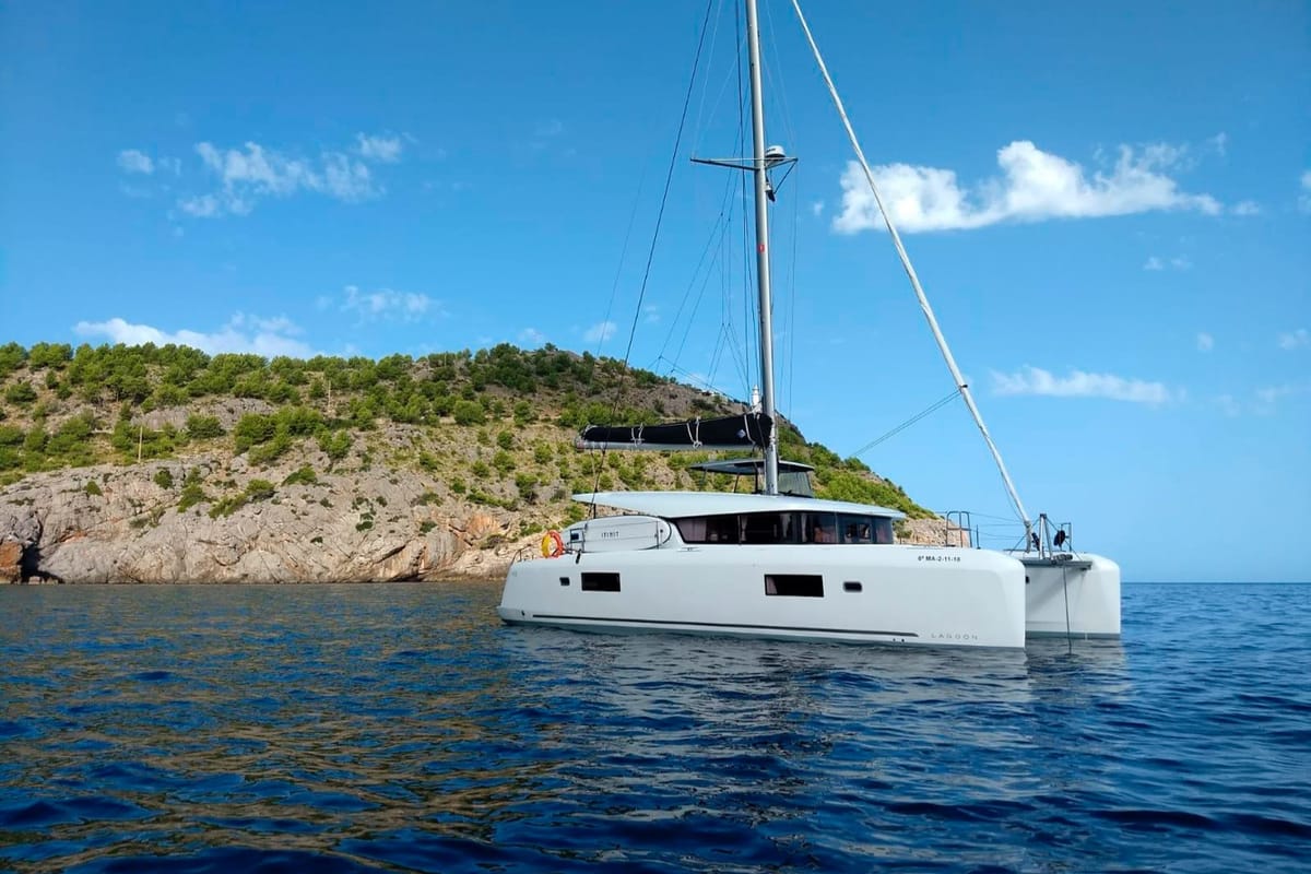 Exterior view of Genista II, a Lagoon 42 catamaran at Sant Antoni de Portmany, Spain