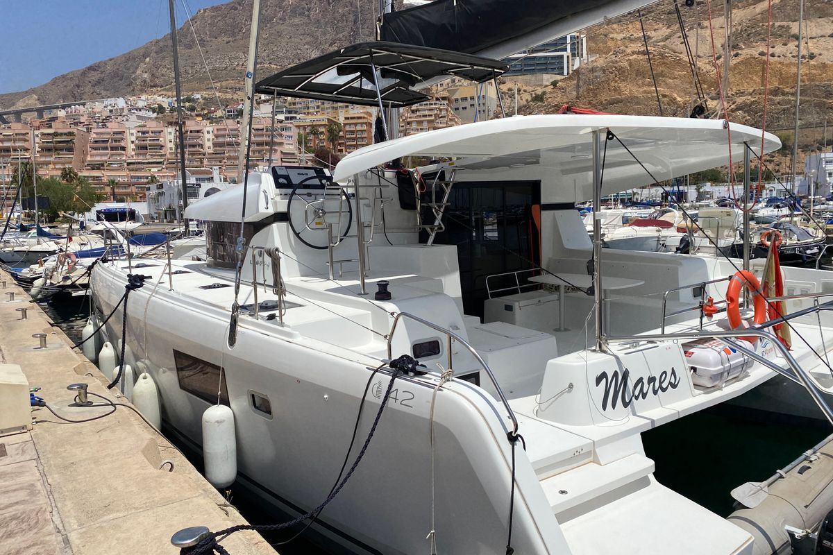 Exterior view of Mares, a Lagoon 42 catamaran at Sant Antoni de Portmany, Spain