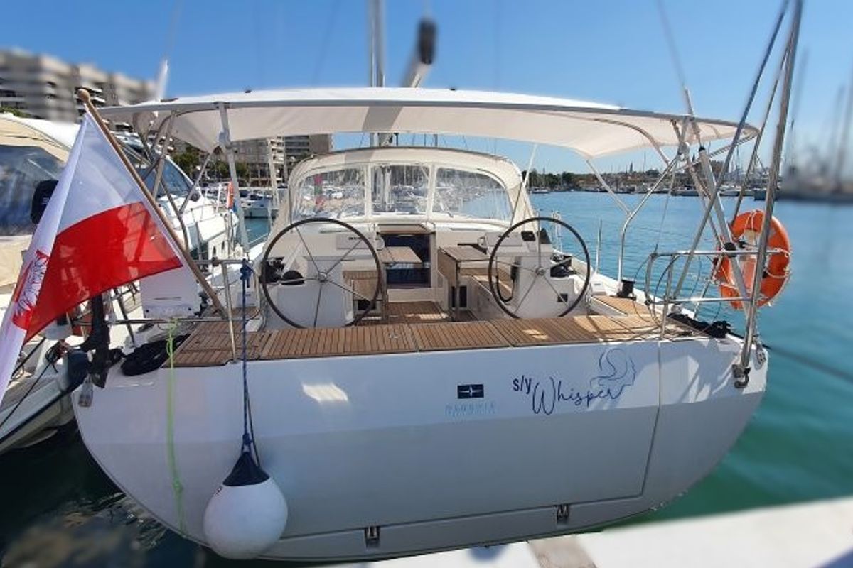 Exterior view of Whisper, a Bavaria C45 sailboat at Cala Egos, Spain