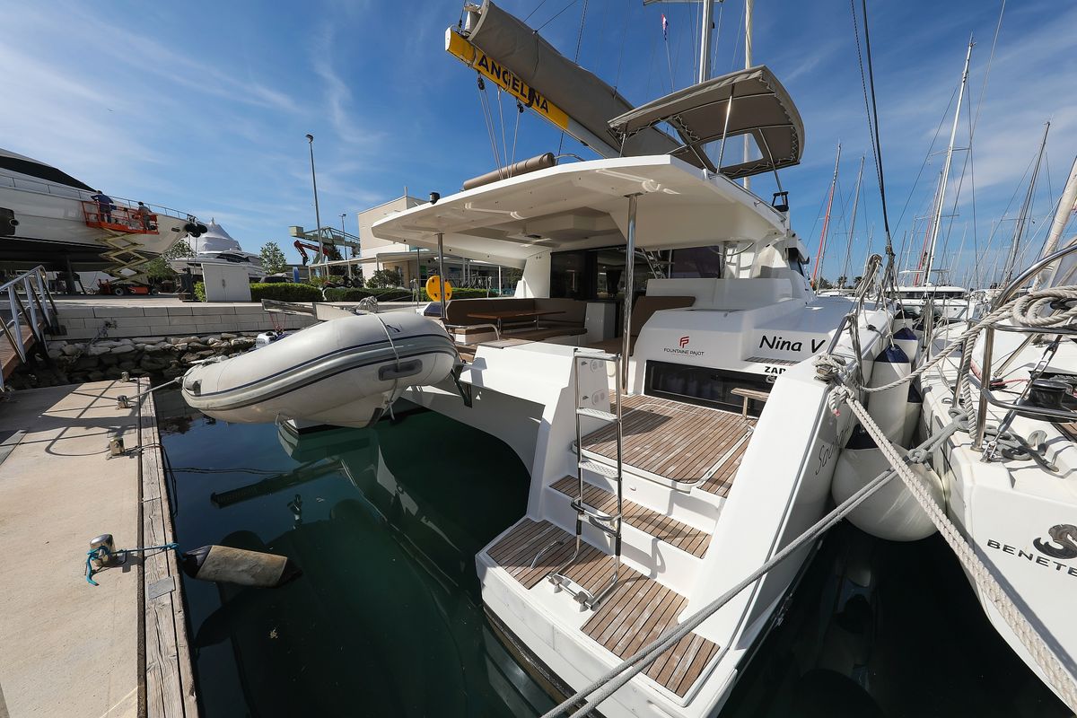 Exterior view of Nina V, a Fountaine Pajot Saona 47 Quintet catamaran at Grad Trogir, Croatia