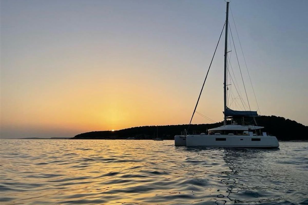 Exterior view of Jolie, a Lagoon 52F catamaran at Sant Antoni de Portmany, Spain