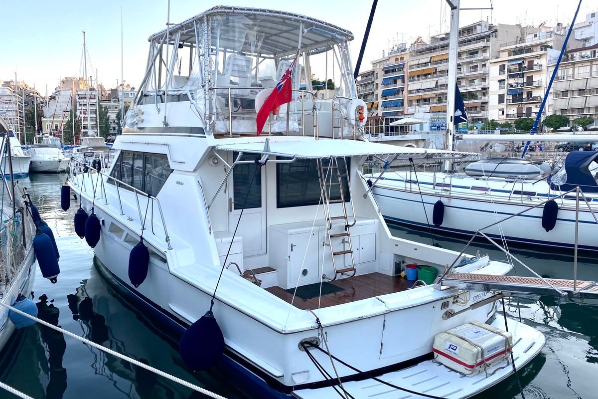 Exterior view of Tipejyas, a Gulet Hatteras 50 Convertible motorboat at Livadi, Greece