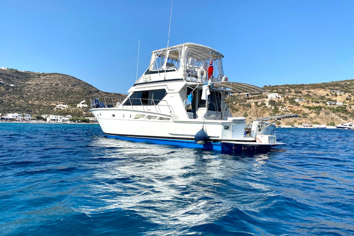 Exterior view of Tipejyas, a Gulet Hatteras 50 Convertible motorboat at Livadi, Greece